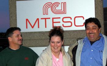 Happy employees stand in front of the RCI sign.